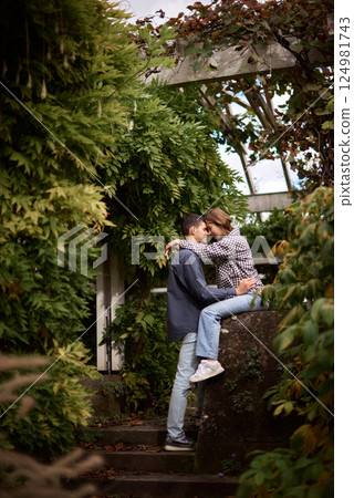 Young Cute Female Hugs Boyfriend. In Autumn Outdoor. Lovers Walking in Park. Attractive Funny Couple. Lovestory in Forest. Man and Woman. Cute Lovers in the Park. Family Concept. Happy Couple. 124981743