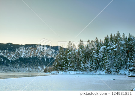 Breathtaking Alpine Winter Wonderland: Majestic Zugspitze Mountain Reflects in Frozen Eibsee Lake Amidst Snowy German Landscape Picturesque Ski Resort Nestled in Bavarian Forest Offers Stunning Breathtaking Alpine Winter Wonderland: Majestic Zugspitze Mountain Reflects in Frozen Eibsee Lake Amidst Snowy German Landscape Picturesque Ski Resort Nestled in Bavarian Forest Offers Stunning 124981831
