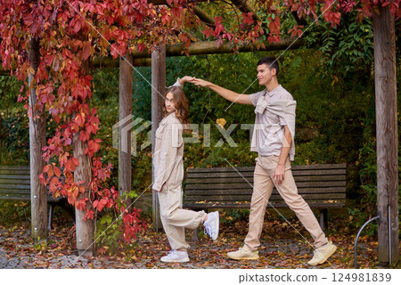Young Cute Female Hugs Boyfriend. In Autumn Outdoor. Lovers Walking in Park. Attractive Funny Couple. Lovestory in Forest. Man and Woman. Cute Lovers in the Park. Family Concept. Happy Couple. 124981839