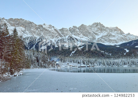 Majestic Frozen Eibsee Lake Reflects Icy Mountain Peaks Under Early Morning Light Pristine Winter Wonderland Captures Nature's Serenity with Snow-Covered Zugspitze in the Background Majestic Frozen Eibsee Lake Reflects Icy Mountain Peaks Under Early Morning Light Pristine Winter Wonderland Captures Nature's Serenity with Snow-Covered Zugspitze in the Background 124982253