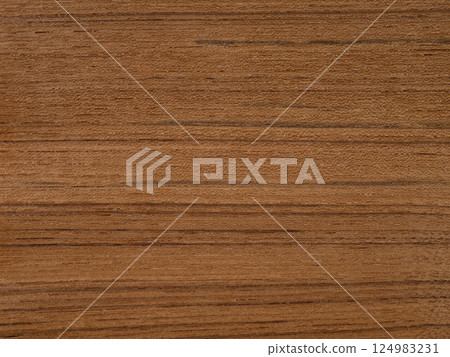 Teak veneer with smooth grain and warm cinnamon wood tones Teak veneer with smooth grain and warm cinnamon wood tones 124983231