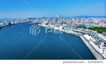 A drone shot of the view from the mouth of the river in Osaka, Tempozan, towards the big city of Osaka Umeda. 124984471