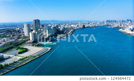 A drone shot of the view from the mouth of the river in Osaka, Tempozan, towards the big city of Osaka Umeda. 124984472