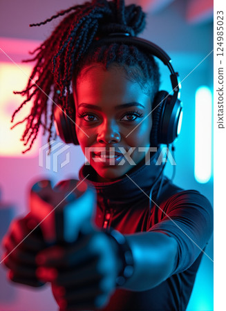 Close-Up Portrait of Woman with Gun in Neon Room 124985023