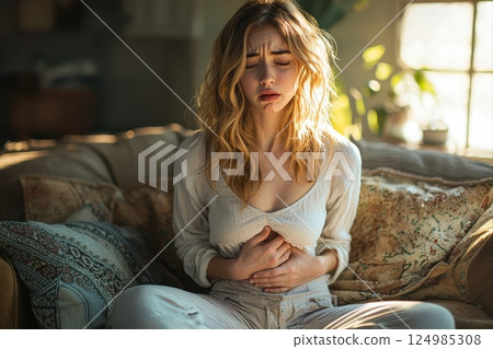 Coping with abdominal pain home emotional expression cozy living room intimate viewpoint health awareness Coping with abdominal pain home emotional expression cozy living room intimate viewpoint health awareness 124985308