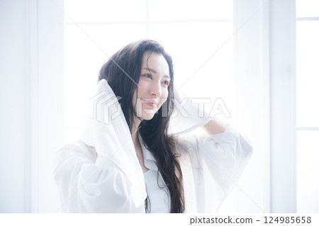 一位女士用毛巾擦乾濕髮 124985658