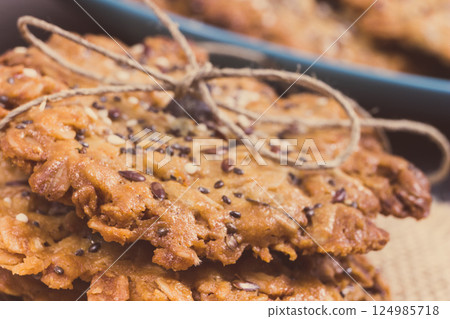Fresh baked oatmeal cookies with honey and healthy seeds. Delicious crunchy dessert Fresh baked oatmeal cookies with honey and healthy seeds. Delicious crunchy dessert 124985718