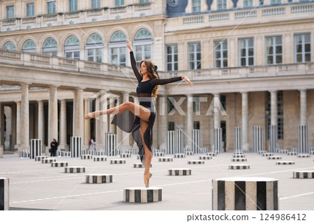 An Elegant Dancer is Gracefully Posing in a Beautiful Parisian Courtyard Full of Charm and History An Elegant Dancer is Gracefully Posing in a Beautiful Parisian Courtyard Full of Charm and History 124986412