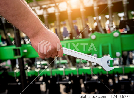 The mechanics repair combine harvester. Modern agricultural machinery The mechanics repair combine harvester. Modern agricultural machinery 124986774
