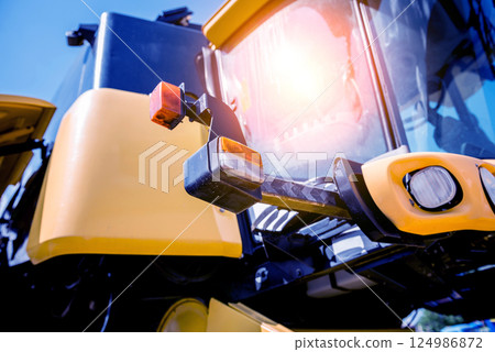 Modern agricultural machinery and equipment. Yellow agricultural harvester. Modern agricultural machinery and equipment. Yellow agricultural harvester. 124986872