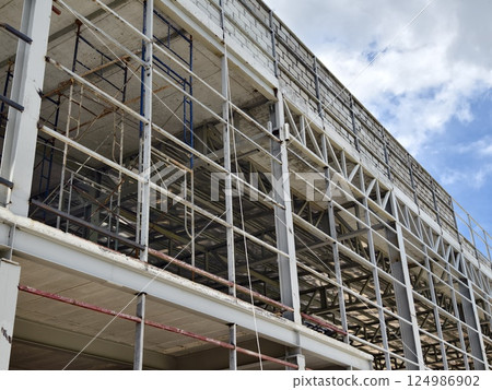 A large and impressive modern building is under construction. A large and impressive modern building is under construction. 124986902