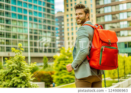 young handsome man with a backpack in a city 124986963
