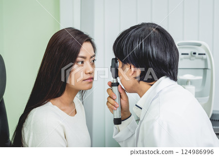Consultation with an ophthalmologist. Young asian woman and doctor Consultation with an ophthalmologist. Young asian woman and doctor 124986996