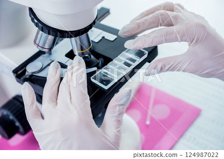 Microscope with metal lens at laboratory. Medical equipment.  124987022