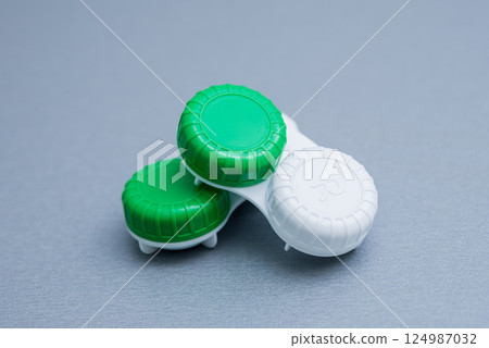 Contact lens container on a gray table. Contact lens container on a gray table. 124987032