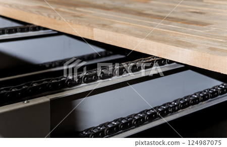 Production line of the wooden floor factory. CNC automatic woodworking machine. Production line of the wooden floor factory. CNC automatic woodworking machine. 124987075