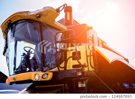 Modern agricultural machinery and equipment. Yellow agricultural harvester. 124987093