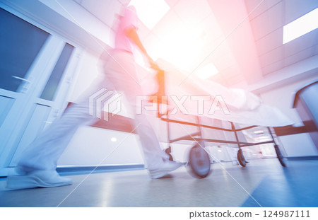 Nurses moves medical stretcher with patient at hospital. Medical equipment. 124987111