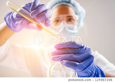 Scientist pouring organic oil. Beauty and cosmetics sciences.  124987206