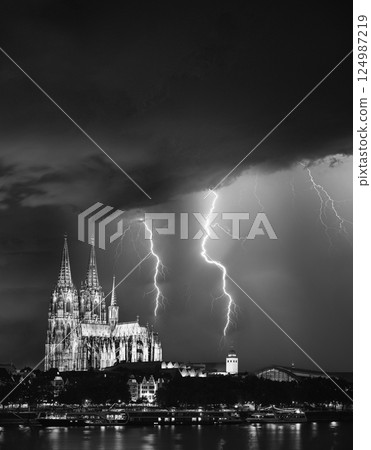 Cologne, Germany. thunder flash in Night sky above Cologne Cathedral. Catholic Gothic Cathedral In Night. UNESCO World Heritage Site. 124987219