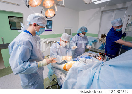 Arthroscope surgery. Orthopedic surgeons in teamwork in the operating room Arthroscope surgery. Orthopedic surgeons in teamwork in the operating room 124987262
