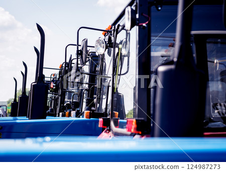 Rows of modern tractors. Industrial details. Agricultural  124987273