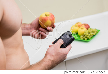 Diabetic man with an insulin pump connected in his abdomen. insulin pump calculates the dose of insulin. Diabetes concept. 124987274