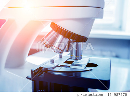Microscope with metal lens at laboratory. Medical equipment. Microscope with metal lens at laboratory. Medical equipment. 124987276