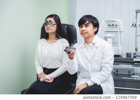 Consultation with an ophthalmologist. Young asian woman and doctor Consultation with an ophthalmologist. Young asian woman and doctor 124987309
