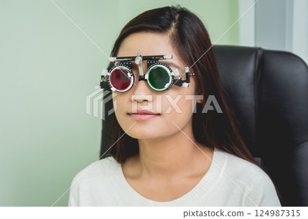 Consultation with an ophthalmologist. Young asian woman in clinic office. Consultation with an ophthalmologist. Young asian woman in clinic office. 124987315
