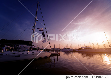 Beautiful view of marina and harbor with yachts and motorboats. Beautiful view of marina and harbor with yachts and motorboats. 124987328
