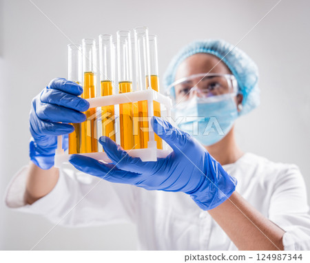 Scientist pouring organic oil. Beauty and cosmetics sciences.  124987344