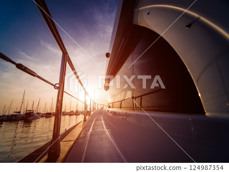 View of harbor with yachts details. Beautiful sunset sky in the marina bay. 124987354