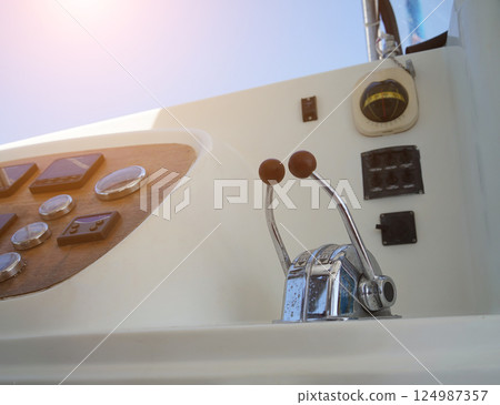 Close up of a steering wheel located on a sailing boat Close up of a steering wheel located on a sailing boat 124987357