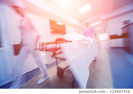 Nurses moves medical stretcher with patient at hospital. Medical equipment. 124987458