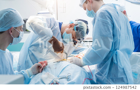 Spinal surgery. Group of surgeons in operating room with surgery equipment. Spinal surgery. Group of surgeons in operating room with surgery equipment. 124987542