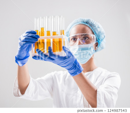 Scientist pouring organic oil. Beauty and cosmetics sciences. Scientist pouring organic oil. Beauty and cosmetics sciences. 124987543
