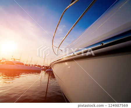 View of harbor with yachts details. Beautiful sunset sky in the marina bay. 124987569