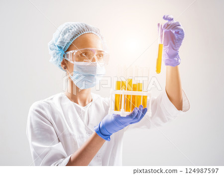 Scientist pouring organic oil. Beauty and cosmetics sciences. Scientist pouring organic oil. Beauty and cosmetics sciences. 124987597