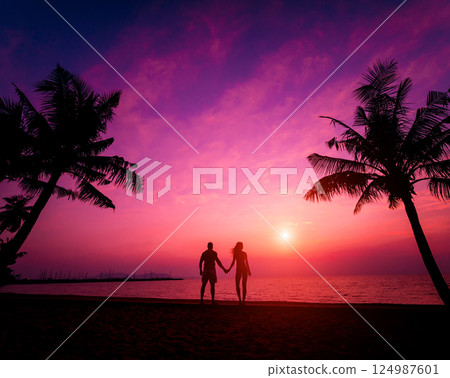 Silhouette of couple on tropical beach during sunset  124987601