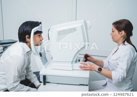 Consultation with an ophthalmologist. Young asian man and woman doctor  124987621