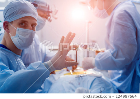 Spinal surgery. Group of surgeons in operating room with surgery equipment. Spinal surgery. Group of surgeons in operating room with surgery equipment. 124987664