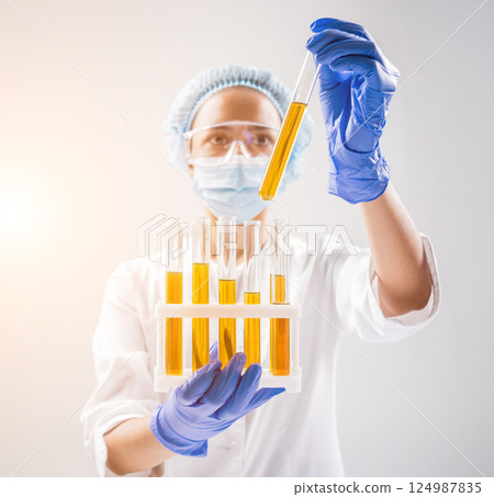 Scientist pouring organic oil. Beauty and cosmetics sciences.  124987835