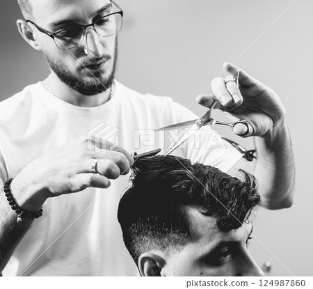 Young man with trendy haircut at barber shop.  124987860