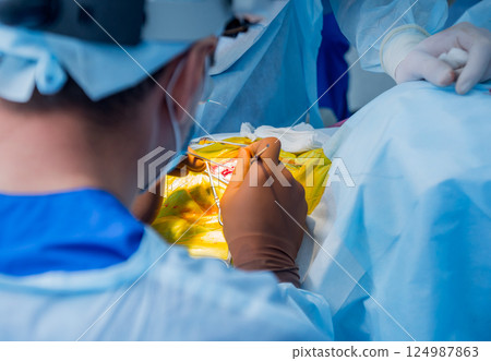 Brain surgery. Group of surgeons in operating room with surgery equipment. 124987863