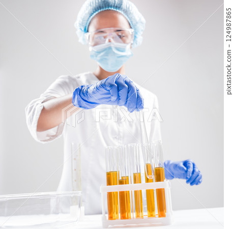 Scientist pouring organic oil. Beauty and cosmetics sciences.  124987865