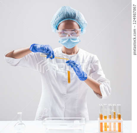 Scientist pouring organic oil. Beauty and cosmetics sciences.  124987867