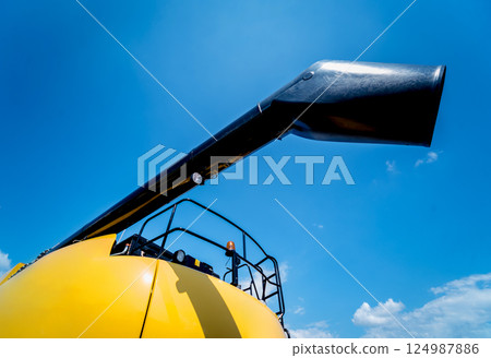 Modern agricultural machinery and equipment. Yellow agricultural harvester. Modern agricultural machinery and equipment. Yellow agricultural harvester. 124987886