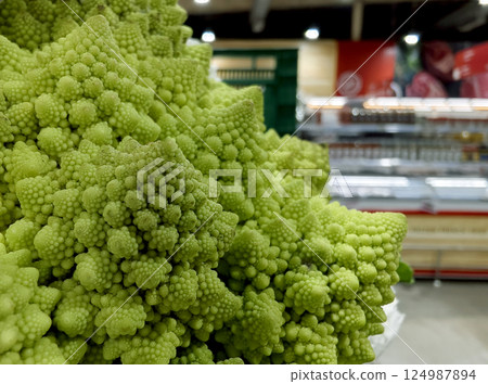 Vibrant green cauliflower on a grocery background Vibrant green cauliflower on a grocery background 124987894
