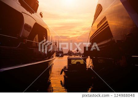 View of harbor with yachts details. Beautiful sunset sky in the marina bay. View of harbor with yachts details. Beautiful sunset sky in the marina bay. 124988048